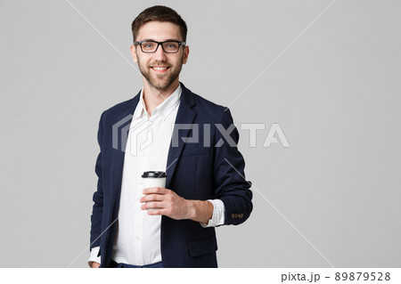 Portrait of a handsome businessman in eyeglasses with a cup of coffee. 89879528