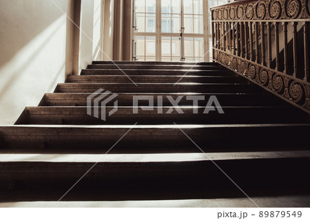 Old stone staircase lit with sun, way up, no people 89879549