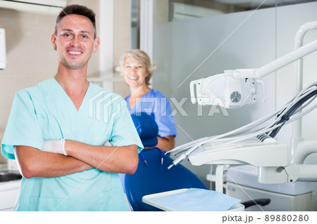 Male dentist in dental office with hands crossed Male dentist in dental office with hands crossed 89880280
