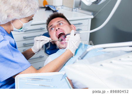 Male patient getting dentist treatment 89880452