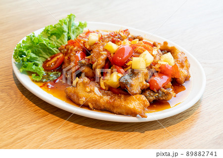 fried grouper fish topped with sweet ,sour and hot sauce fried grouper fish topped with sweet ,sour and hot sauce 89882741