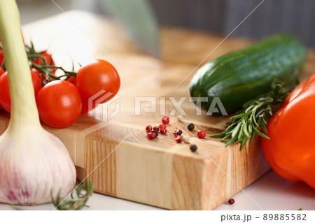 Wooden cutting board with cutted pieces of vegetables, fresh ingredients for salad Wooden cutting board with cutted pieces of vegetables, fresh ingredients for salad 89885582