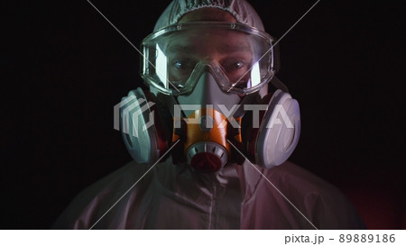 Man in protective costume suit, gas protect medical spray paint mask. Doctor in respirator. Concept health virus coronavirus epidemic. 89889186