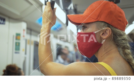 Woman travel caucasian ride at overground train airtrain with wearing protective medical mask. Girl tourist at airtrain with respirator. People mask. Woman travel caucasian ride at overground train airtrain with wearing protective medical mask. Girl tourist at airtrain with respirator. People mask. 89889350