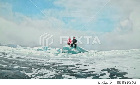 Couple has fun during winter walk against background of ice of f 89889503