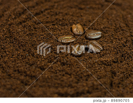 Five coffee beans in the form of a star on a background of freshly ground coffee Five coffee beans in the form of a star on a background of freshly ground coffee 89890705