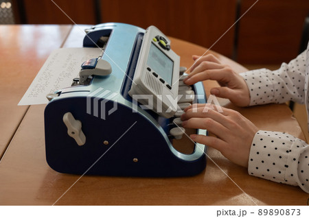 Blind woman using braille typewriter. Blind woman using braille typewriter. 89890873