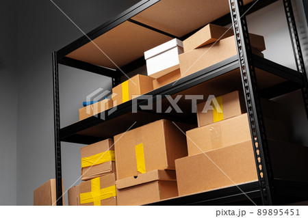 Rack shelves with paper boxes in warehouse. Rack shelves with paper boxes in warehouse. 89895451