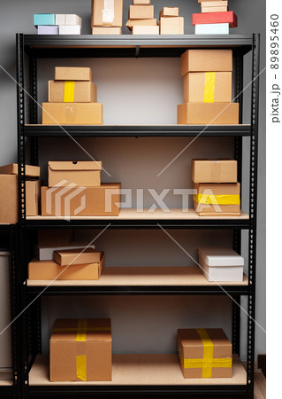 Rows of shelves with cardboard boxes in modern warehouse Rows of shelves with cardboard boxes in modern warehouse 89895460
