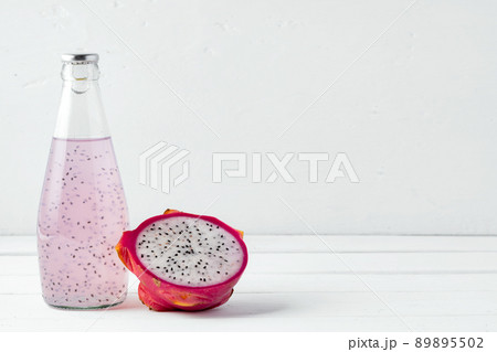 Glass bottle of dragon fruit drink on white background Glass bottle of dragon fruit drink on white background 89895502