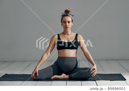 Pregnant Woman Stretching Arms And Legs, Doing Prenatal Workout At Home On Yoga Mat. Selective focus 89896001