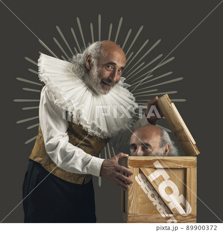 Contemporary art collage. Man in medieval costume opening box with head appearing isolated on dark grey background. Hiding secrets Contemporary art collage. Man in medieval costume opening box with head appearing isolated on dark grey background. Hiding secrets 89900372