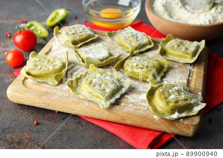 Concept of cooking ravioli on dark background 89900940