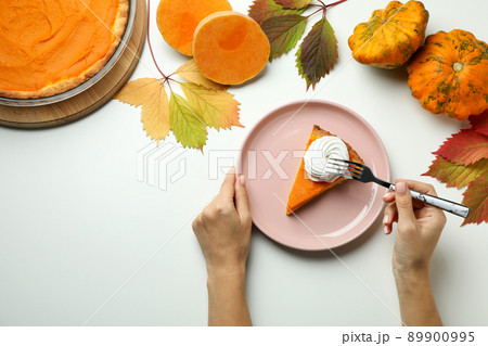 Concept of tasty eating with pumpkin pie on white background 89900995