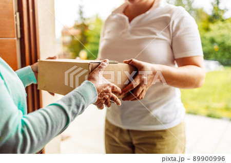 Delivery staff carrying paper boxes. Shop online and express delivery during the Covid-19 crisis. 89900996