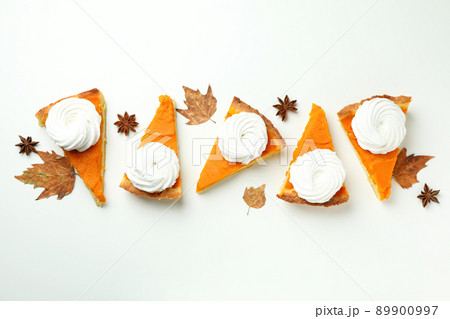 Flat lay composition with pieces of pumpkin pie on white background 89900997