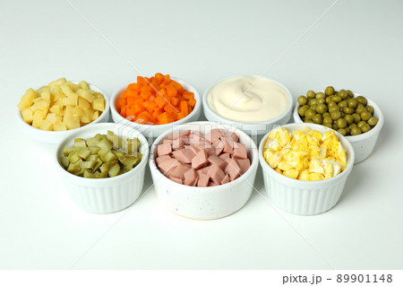 Bowls with Olivier salad ingredients on white background 89901148
