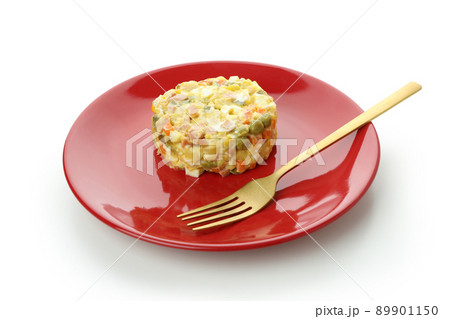 Plate with Olivier salad and fork isolated on white background 89901150