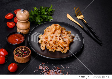 Tasty appetizing pasta tagliatelle spaghetti with tomato sauce and parmesan Tasty appetizing pasta tagliatelle spaghetti with tomato sauce and parmesan 89901671