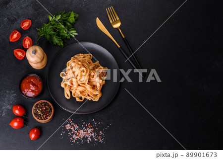Tasty appetizing pasta tagliatelle spaghetti with tomato sauce and parmesan 89901673