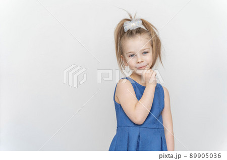 portrait of a cute 5 year old girl on a light background 89905036