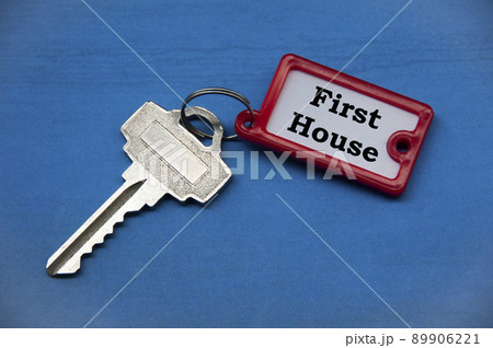 First house text on key chain. Property investment concept. 89906221