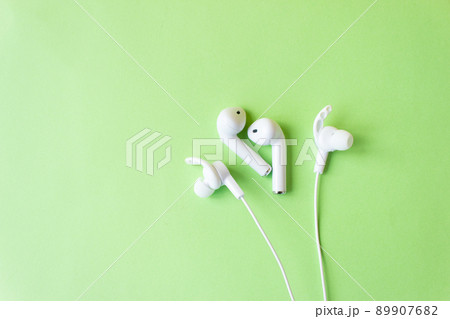 White headphones for talking and listening to music. Gadget and technology concept with copy space. White headphones for talking and listening to music. Gadget and technology concept with copy space. 89907682