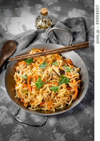 Fried noodles with chicken and vegetables. Fried noodles with chicken and vegetables. 89908607