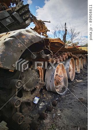 Kyiv region, Ukraine - May 15, 2022: War in Ukraine. Highway Kyiv - Zhytomyr. People take selfies against destroyed russian tank after russian atack in Febrary. 89908811