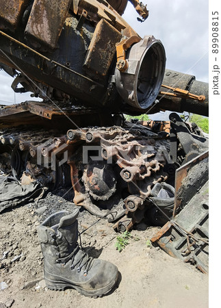 Kyiv region, Ukraine - May 15, 2022: War in Ukraine. Highway Kyiv - Zhytomyr. People take selfies against destroyed russian tank after russian atack in Febrary. 89908815