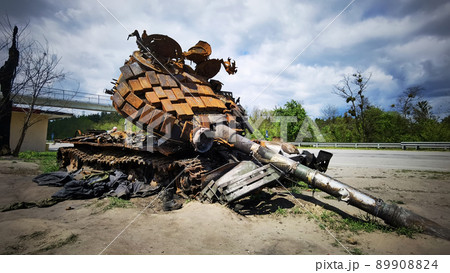 Kyiv region, Ukraine - May 15, 2022: War in Ukraine. Highway Kyiv - Zhytomyr. People take selfies against destroyed russian tank after russian atack in Febrary. 89908824