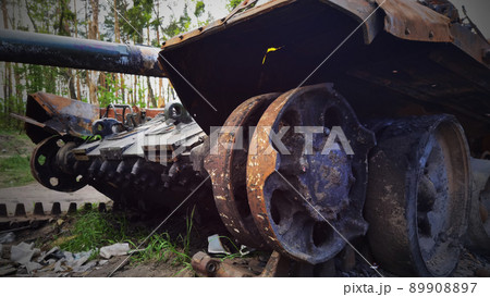 Kyiv region, Ukraine - May 15, 2022: War in Ukraine. Highway Kyiv - Zhytomyr. People take selfies against destroyed russian tank after russian atack in Febrary. 89908897