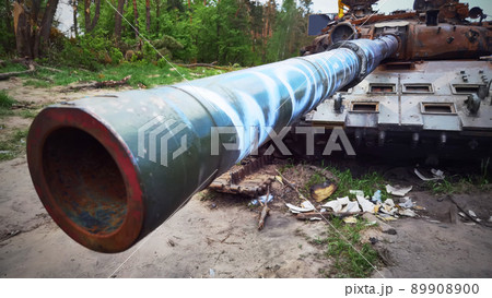 Kyiv region, Ukraine - May 15, 2022: War in Ukraine. Highway Kyiv - Zhytomyr. People take selfies against destroyed russian tank after russian atack in Febrary. 89908900