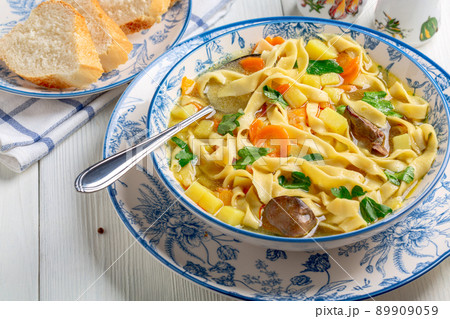 Homemade noodles with chicken broth and vegetables. 89909059