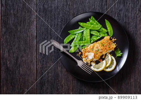 Baked Haddock with Crackers toppings and snow peas Baked Haddock with Crackers toppings and snow peas 89909113