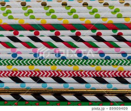 Top view of multi-colored paper disposable eco-friendly straws for summer cocktails. 89909409