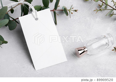 Rectangle white gift tag mockup with eucalyptus leaves on grey background, label tag mockup, Wedding favor tag 89909520