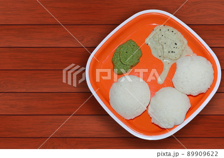 South Indian breakfast Idli with coconut chutney and coriander mint chutney on a plate South Indian breakfast Idli with coconut chutney and coriander mint chutney on a plate 89909622