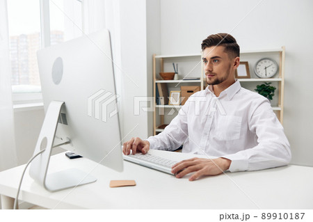 businessmen sitting at a desk in front of a computer with a keyboard executive 89910187