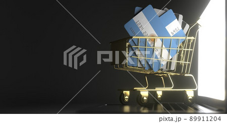 Shopping cart full of credit cards mockups with flags of Argentina on the laptop. 3D rendering 89911204