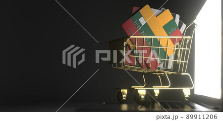 Credit card mockups with flags of Lithuania in a small shopping cart on the laptop. 3D rendering Credit card mockups with flags of Lithuania in a small shopping cart on the laptop. 3D rendering 89911206