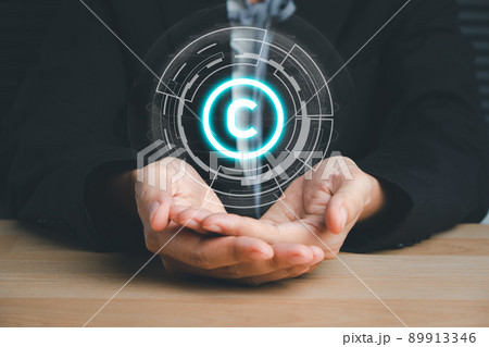 Copyright or patent concept, Business person hand holding VR screen copyright icon with blue bokeh background, Copyleft trademark license, Creation ownership against piracy crime. 89913346
