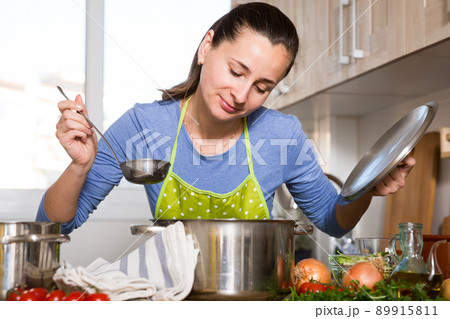 Housewife cooking vegetable soup 89915811