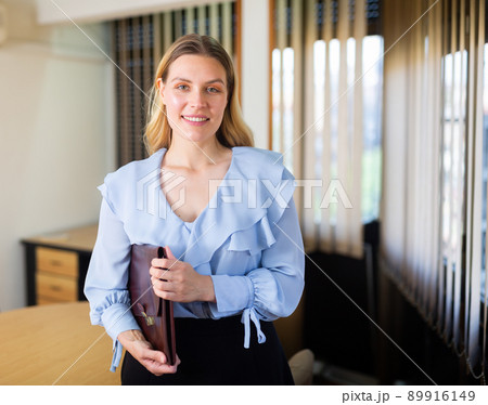 Business woman posing in her office Business woman posing in her office 89916149
