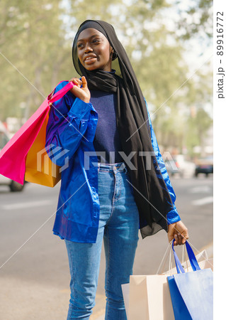 Muslim shopaholic standing near road Muslim shopaholic standing near road 89916772