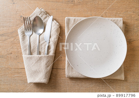 empty plate or dish with knife, fork and spoon empty plate or dish with knife, fork and spoon 89917796