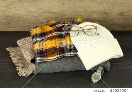 Concept of winter clothes on dark wooden table 89922504