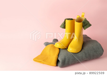 Sweater, knitted hat and boots on pink background Sweater, knitted hat and boots on pink background 89922509