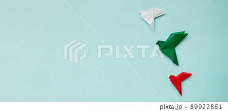 three paper origami pigeons red, white, green on light background 89922861