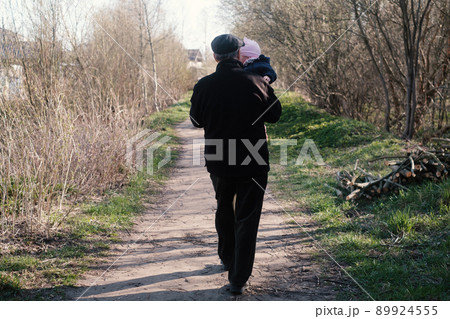 Caucasian grandfather walking with a baby playing spending time together. 89924555